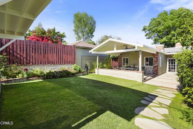 view of yard featuring a patio and a ceiling fan