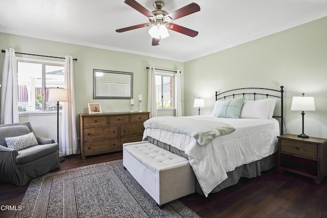 bedroom with wood finished floors, crown molding, and a ceiling fan