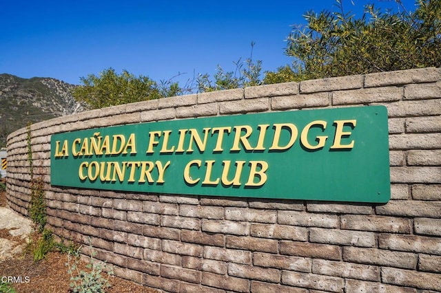 community / neighborhood sign with a mountain view