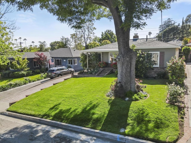 ranch-style house with a front lawn and stucco siding