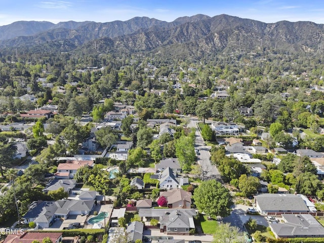 aerial overview of property's location featuring mountains and nearby suburban area