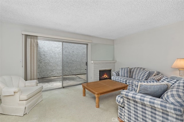 carpeted living area featuring a textured ceiling and a fireplace