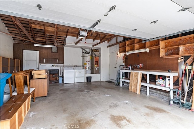 garage featuring washer and dryer, secured water heater, a workshop area, and a garage door opener