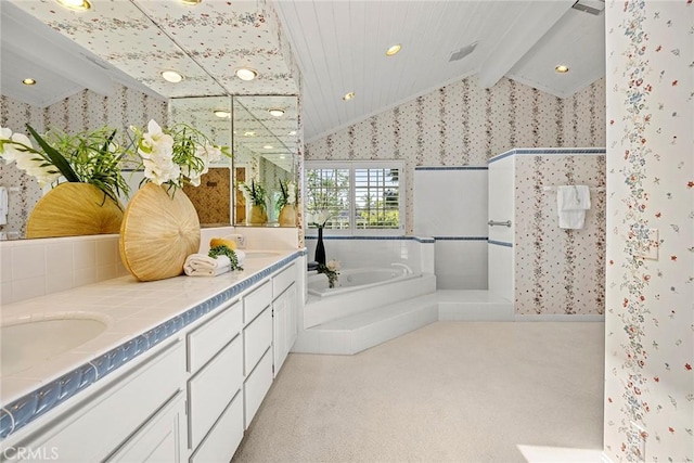 bathroom with wallpapered walls, lofted ceiling, a bath, walk in shower, and double vanity