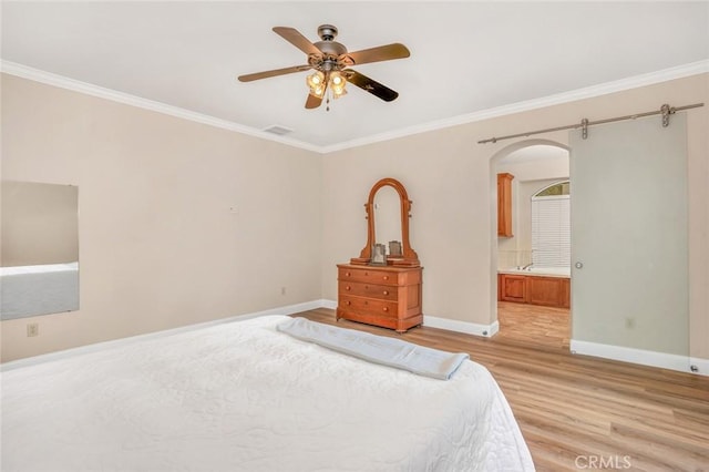 3894 Avocet Dr, Merced, CA 95340 - bedroom featuring arched walkways, ornamental molding, baseboards, light wood-style floors, and connected bathroom