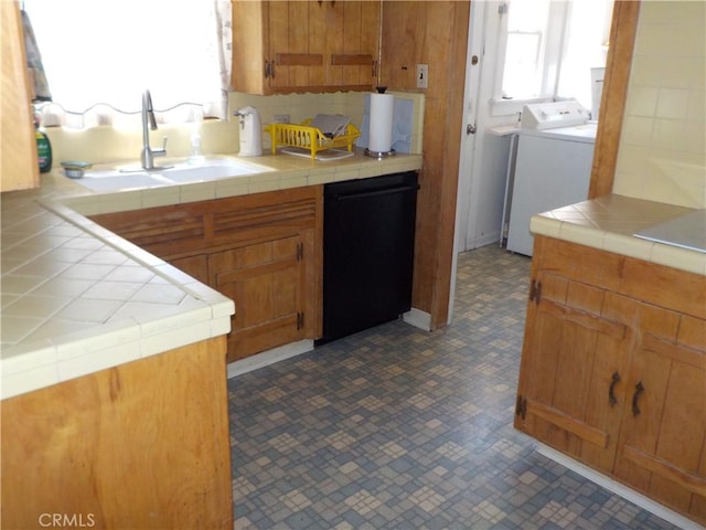 2698 Fremontia Dr, San Bernardino, CA 92404 - kitchen featuring washer / clothes dryer, black dishwasher, a sink, and tile counters