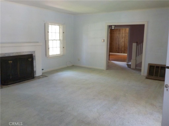 2698 Fremontia Dr, San Bernardino, CA 92404 - unfurnished living room featuring a high end fireplace, stairway, carpet, and baseboards