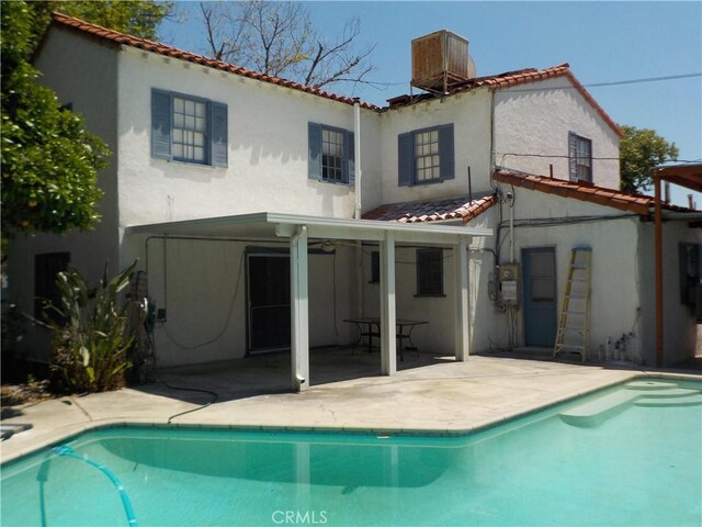 2698 Fremontia Dr, San Bernardino, CA 92404 - back of house featuring stucco siding, a patio area, and a tile roof