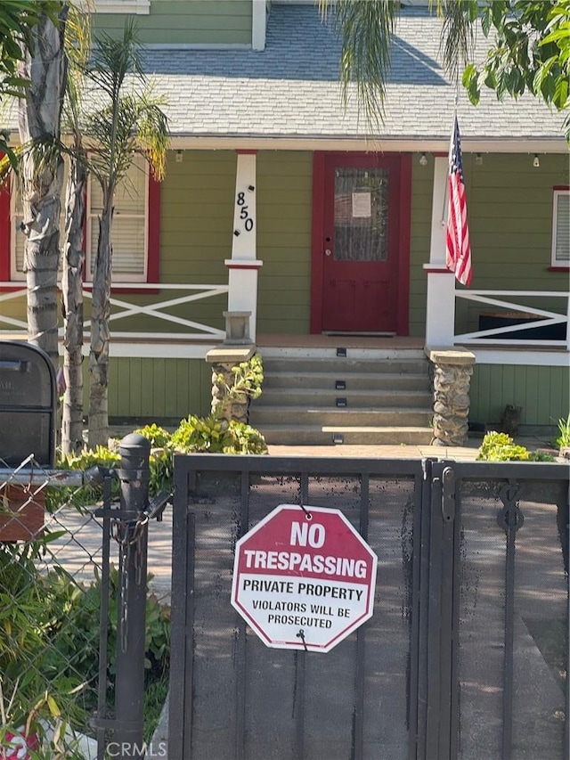 850 E Columbia Ave, Pomona, CA 91767 - property entrance featuring covered porch and fence