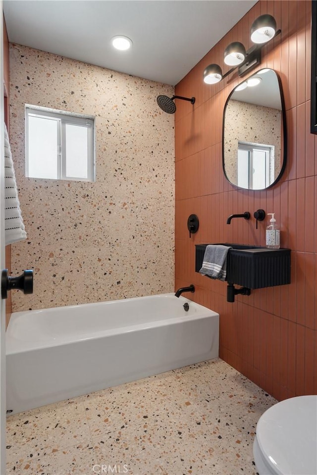 full bathroom featuring  shower combination, plenty of natural light, and toilet