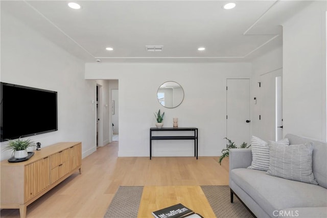 living area with light wood finished floors, recessed lighting, and baseboards