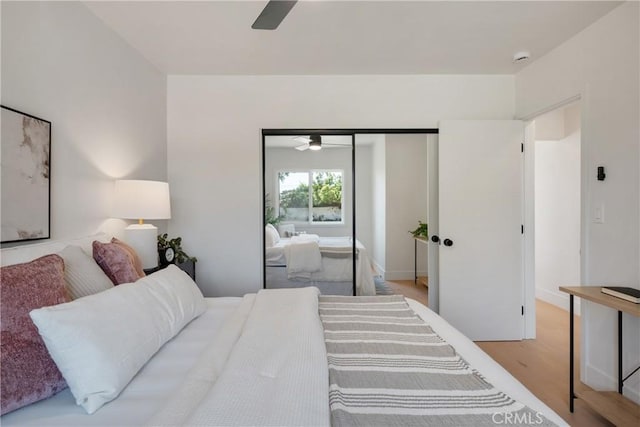 bedroom featuring a closet, wood finished floors, and a ceiling fan