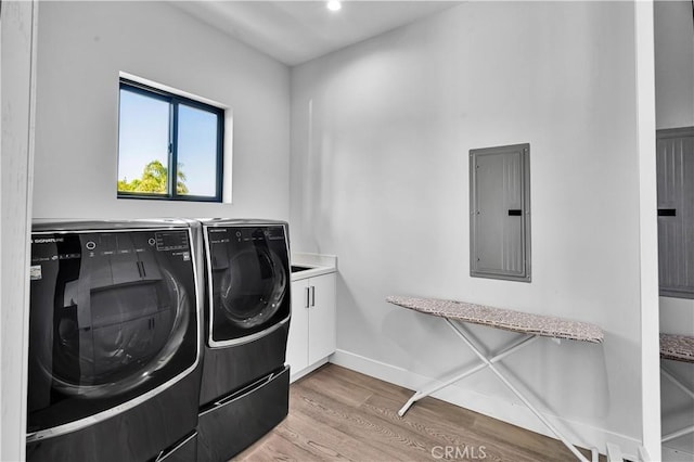 9218 Encino Ave, Northridge, CA 91325 - clothes washing area with electric panel, independent washer and dryer, light wood-style floors, cabinet space, and baseboards