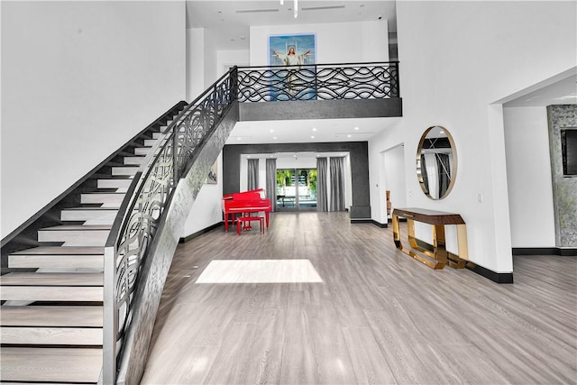 9218 Encino Ave, Northridge, CA 91325 - foyer featuring stairs, wood finished floors, a towering ceiling, and baseboards