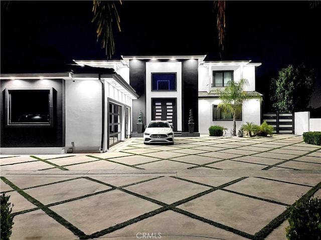 9218 Encino Ave, Northridge, CA 91325 - back of house at twilight with stucco siding, french doors, and fence