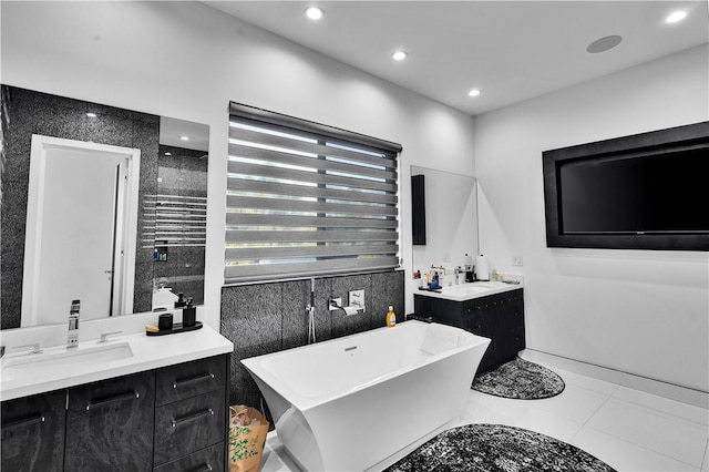 9218 Encino Ave, Northridge, CA 91325 - bathroom with two vanities, a freestanding tub, tile patterned floors, recessed lighting, and tile walls