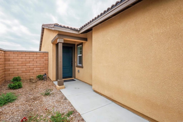25601 Pine Ridge Rd, Homeland, CA 92548 - property entrance featuring stucco siding, fence, and a tile roof