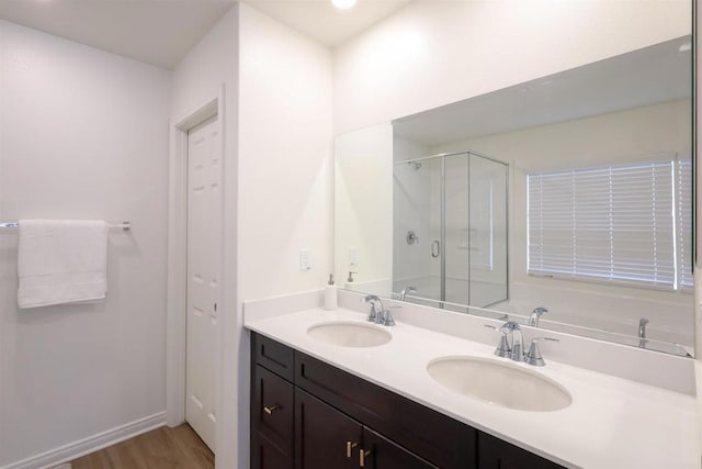 25601 Pine Ridge Rd, Homeland, CA 92548 - full bathroom with a stall shower, a bath, wood finished floors, double vanity, and baseboards