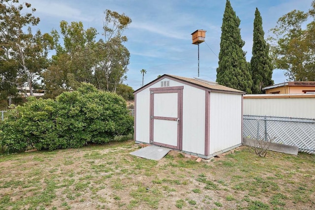 view of shed with fence