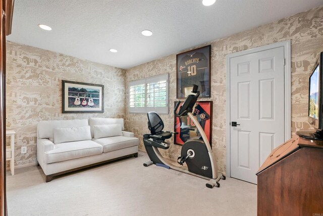 exercise area featuring wallpapered walls, recessed lighting, carpet floors, and a textured ceiling