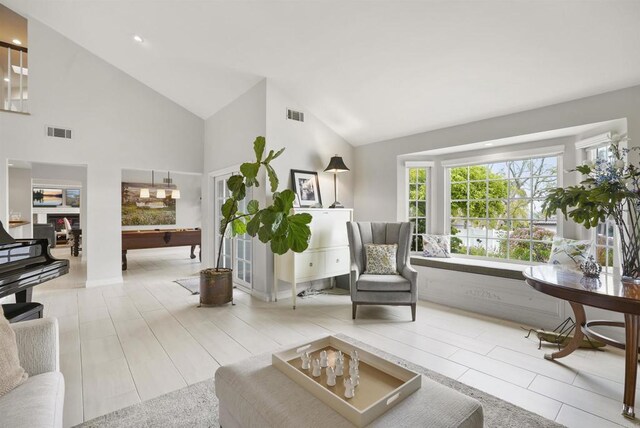 living area with billiards table and high vaulted ceiling