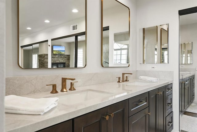 full bath with double vanity and recessed lighting