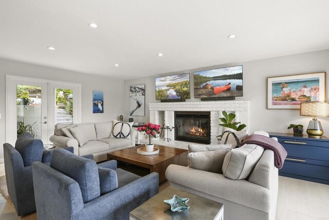 living area with a brick fireplace and recessed lighting