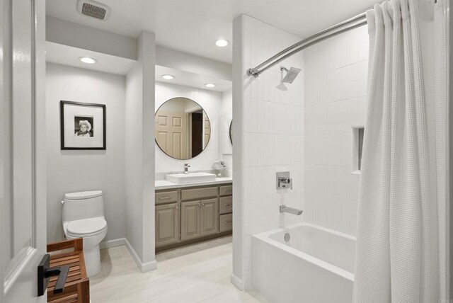bathroom featuring toilet, shower / bath combo, vanity, recessed lighting, and tile patterned floors