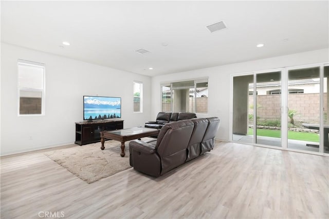living area with wood finished floors, baseboards, and recessed lighting