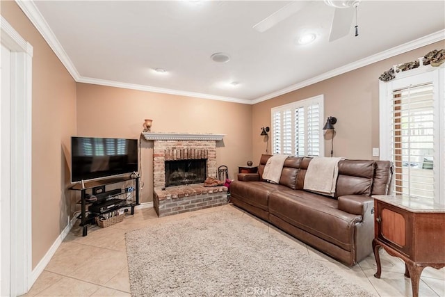 living room with crown molding, a fireplace, ceiling fan, light tile patterned flooring, and baseboards