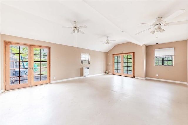 unfurnished living room with concrete floors, a ceiling fan, baseboards, vaulted ceiling, and french doors