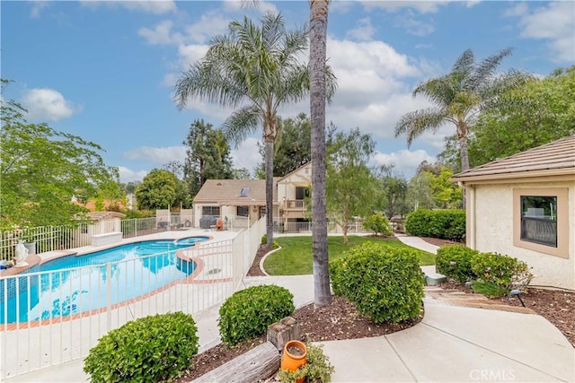 view of swimming pool featuring fence and a patio