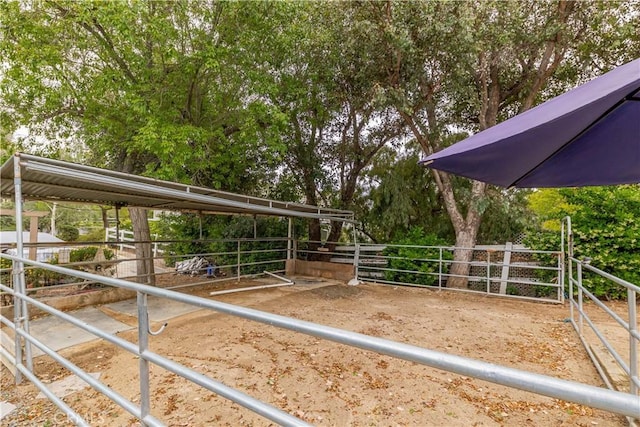 horse barn with view of wooded area