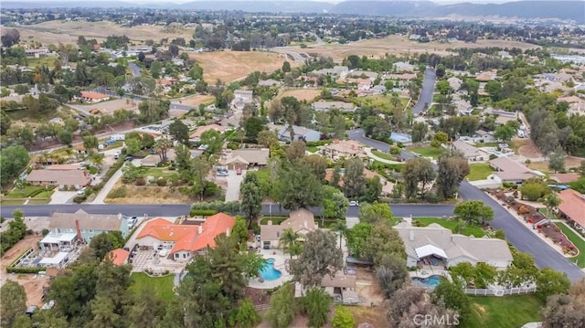 aerial overview of property's location with nearby suburban area and a mountain backdrop