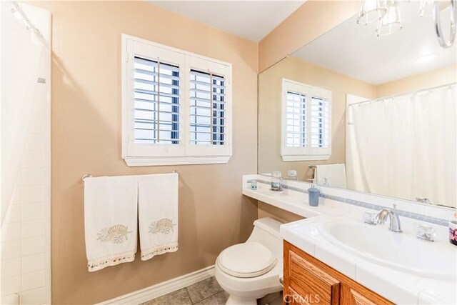full bathroom with baseboards, toilet, vanity, curtained shower, and tile patterned floors