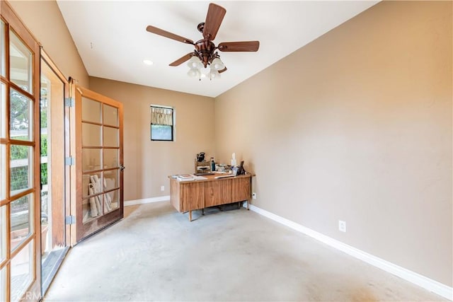 office featuring baseboards, concrete floors, and a ceiling fan