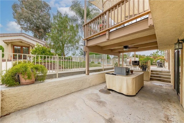view of patio with fence and ceiling fan