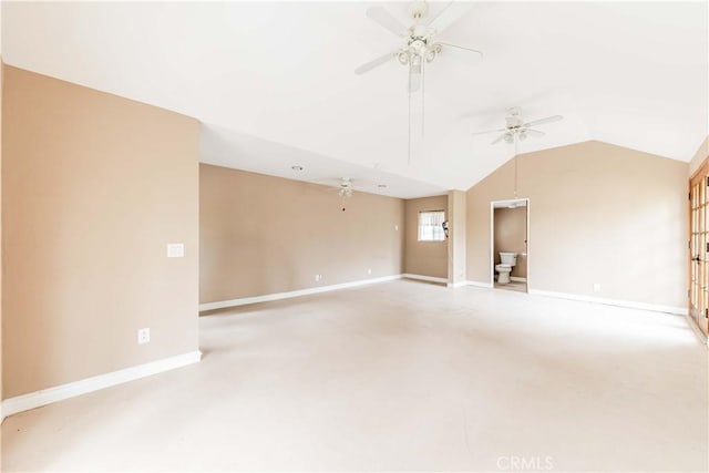spare room featuring ceiling fan, baseboards, lofted ceiling, and light carpet