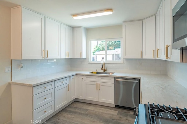 818 Invergarry St, Glendora, CA 91741 - kitchen with appliances with stainless steel finishes, a sink, white cabinetry, and backsplash