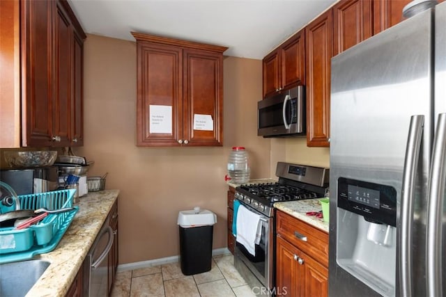 4731-33 Austin Dr, San Diego, CA 92115 - kitchen with appliances with stainless steel finishes, light stone counters, and baseboards