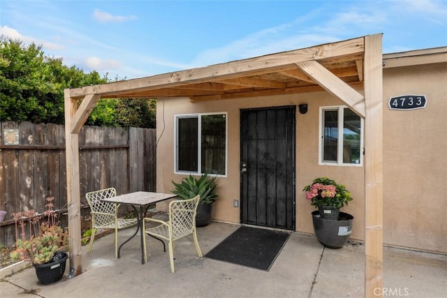 4731-33 Austin Dr, San Diego, CA 92115 - property entrance with a patio, fence, stucco siding, and outdoor dining area
