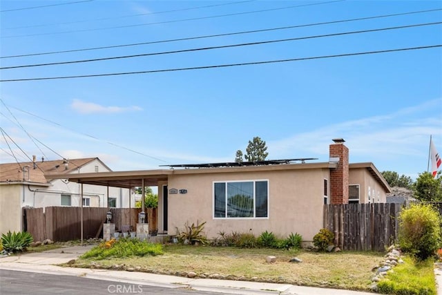 4731-33 Austin Dr, San Diego, CA 92115 - view of front of house with stucco siding, solar panels, and a chimney