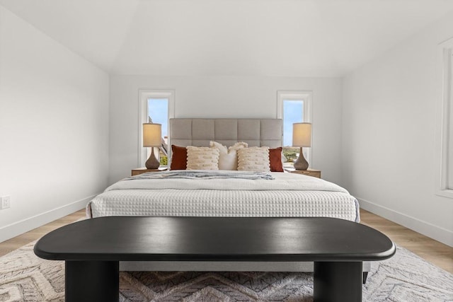 bedroom with baseboards and light wood-style flooring