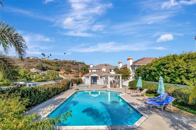 view of swimming pool with a pergola, a patio, and fence