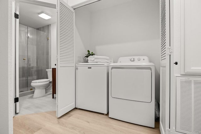washroom featuring separate washer and dryer and light wood-type flooring