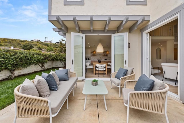 view of patio / terrace featuring an outdoor living space and fence