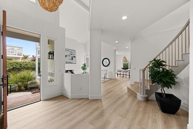 foyer entrance featuring healthy amount of natural light, stairway, light wood-style floors, baseboards, and recessed lighting