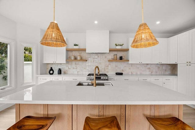 kitchen with open shelves, light countertops, decorative backsplash, and recessed lighting
