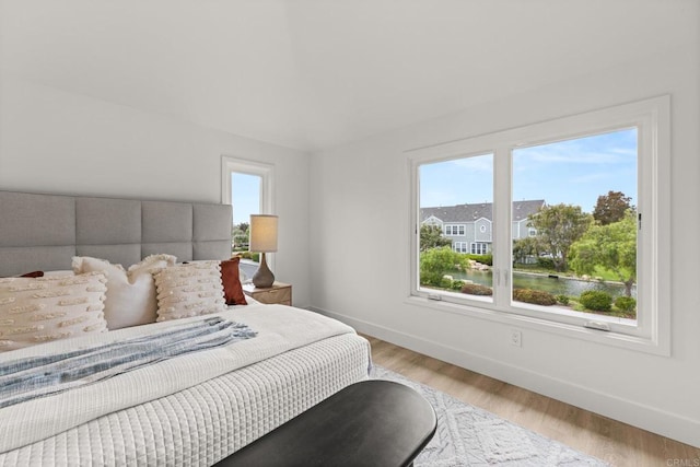 bedroom featuring baseboards and wood finished floors
