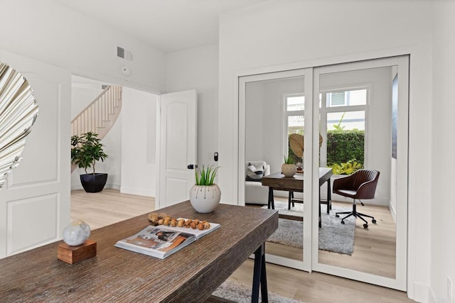 office with light wood-style flooring and baseboards